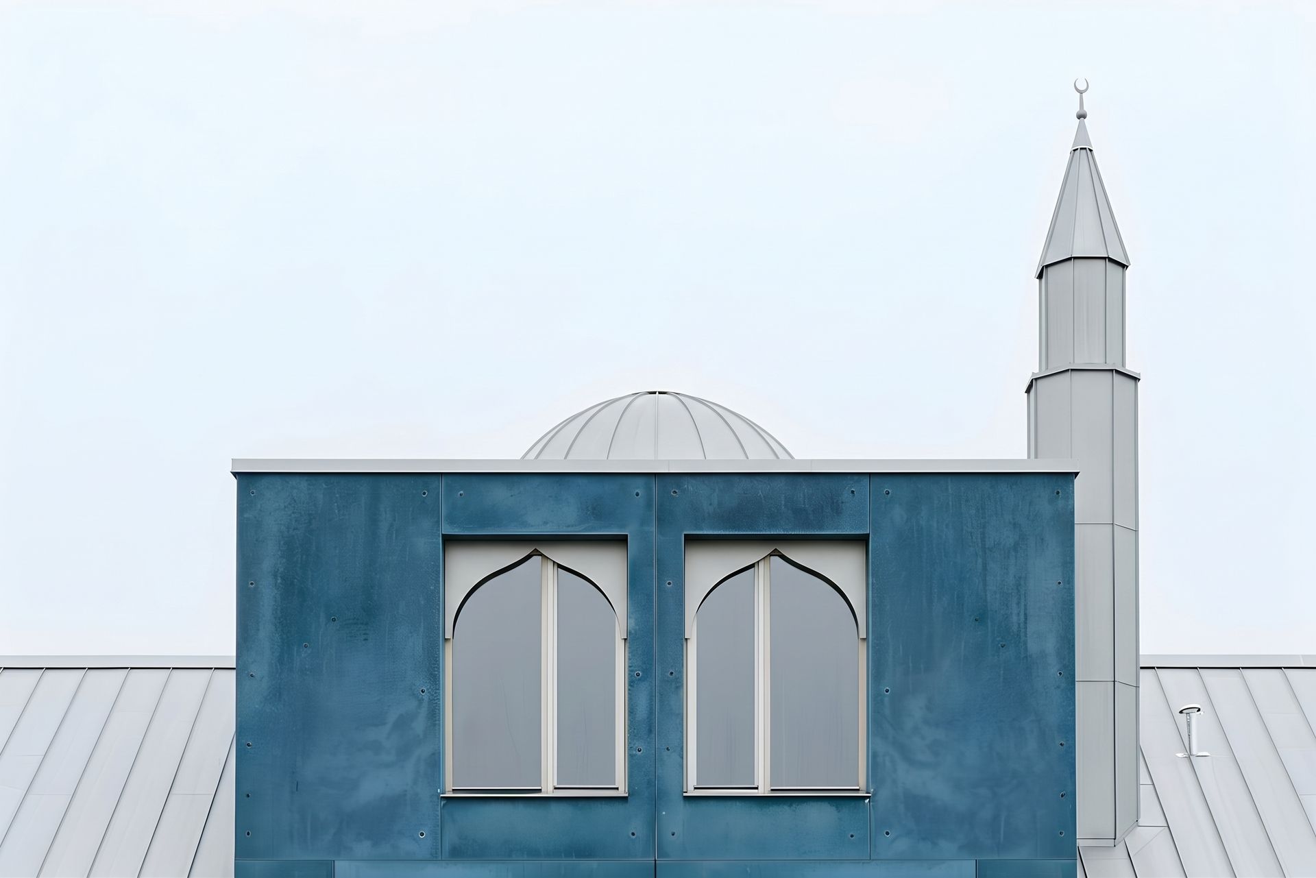 Blue panelled prayer hall of Fjordlys Mosque with its shallow dome and slender minaret